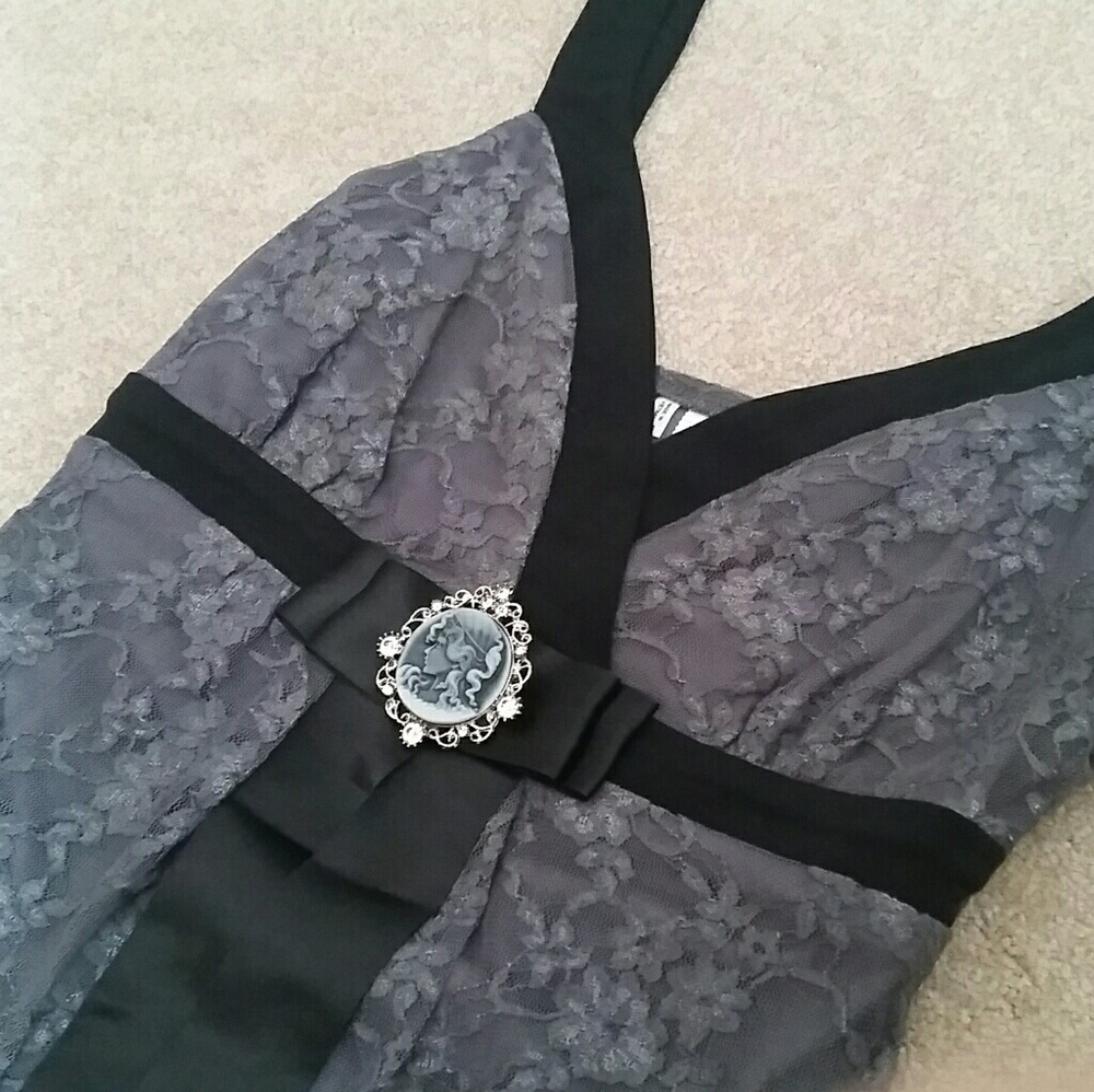Lace top with cameo pin and black ribbon detail